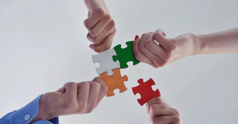 Group of business people assembling jigsaw puzzle and represent team support and help concept