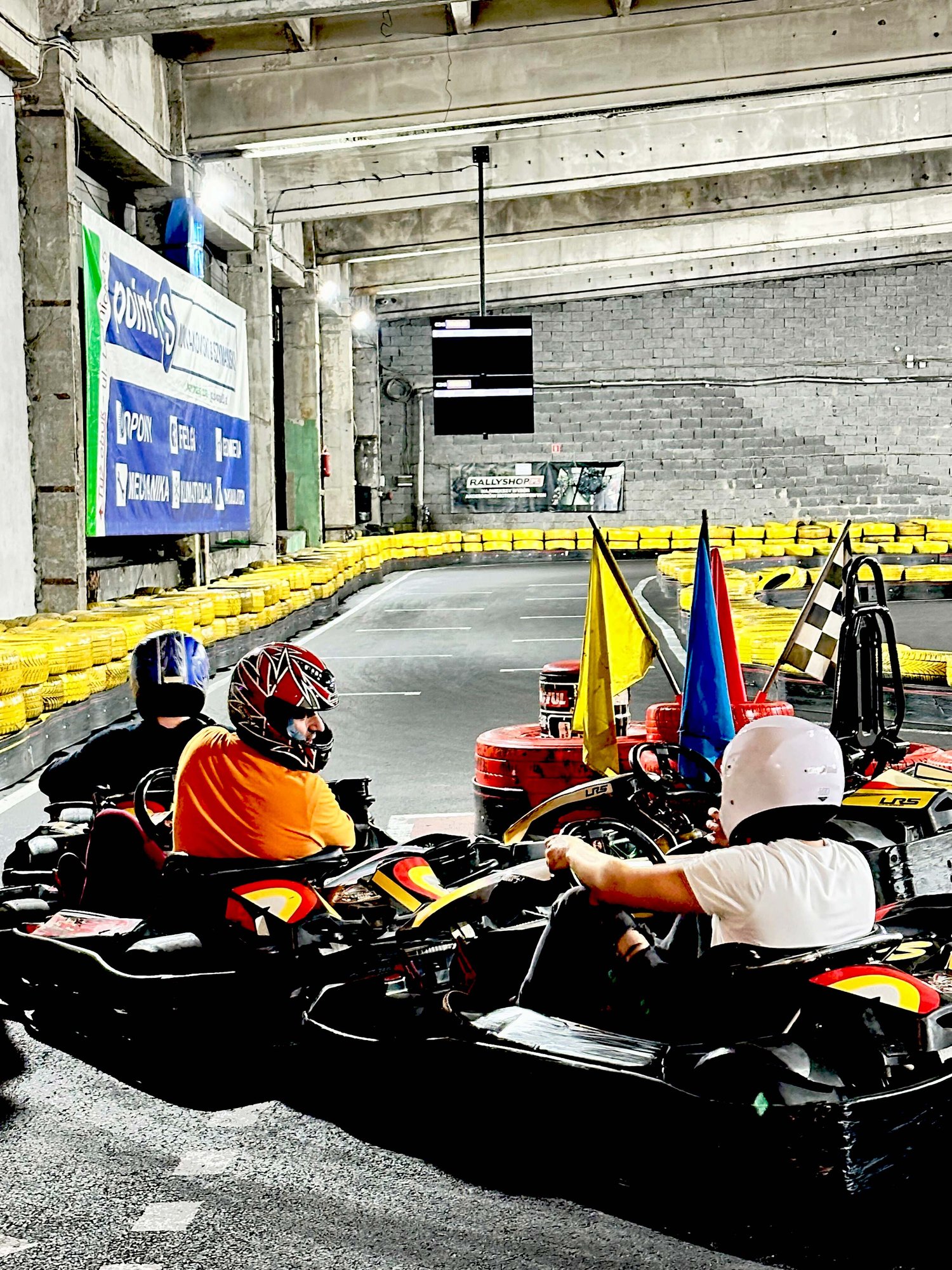 3 columbus employees driving go-carts on a track