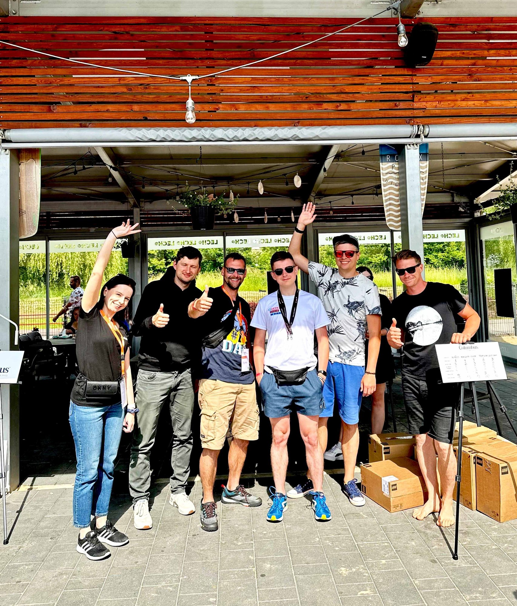 Group of columbus employees smiling and waving to the camera.