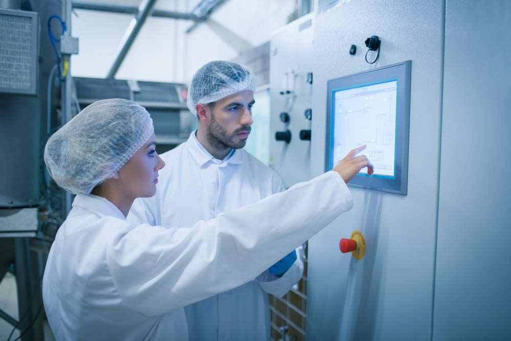 Food technicians working together in a food processing plant-3