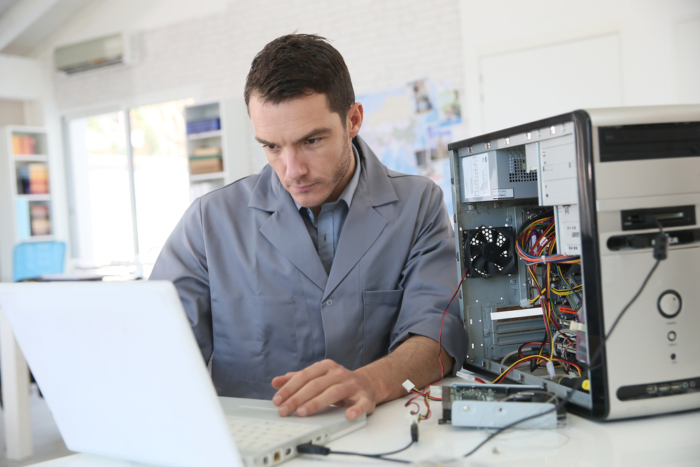 Technician fixing computer hardware-1